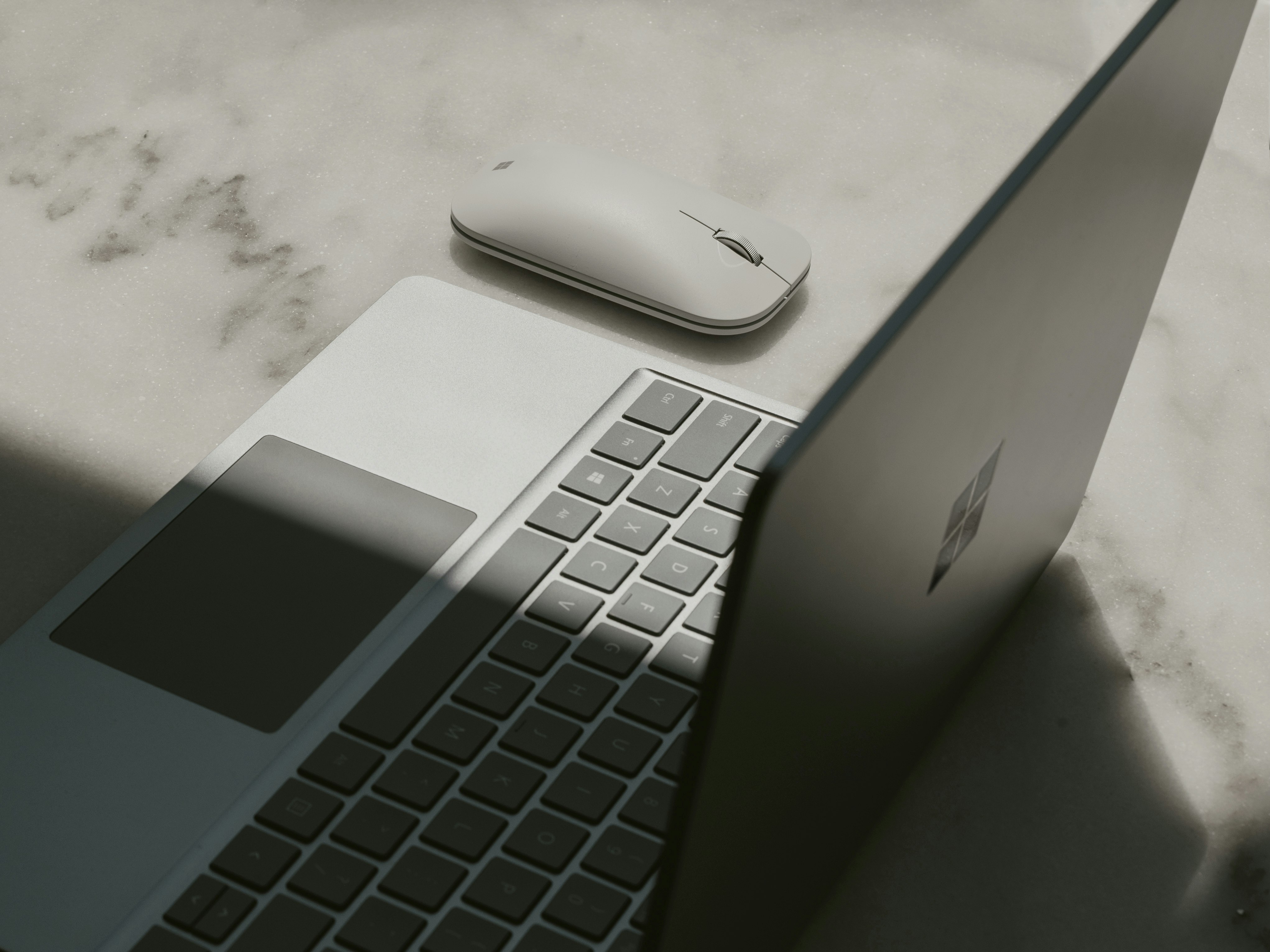 Surface laptop next to mouse
